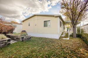 View of side of property with a yard