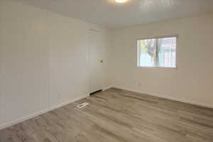 Unfurnished room with light wood-type flooring