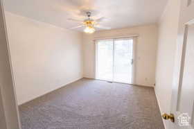 Spare room featuring ceiling fan and carpet floors