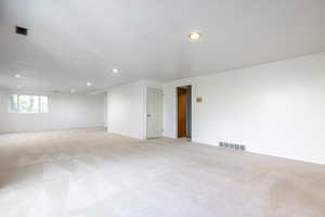 Unfurnished room with light colored carpet