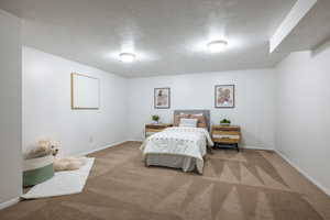 Carpeted bedroom featuring a textured ceiling