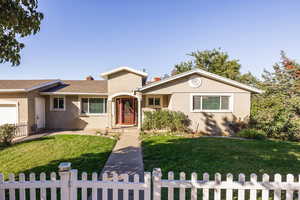 View of front of home featuring a front yard and a garage