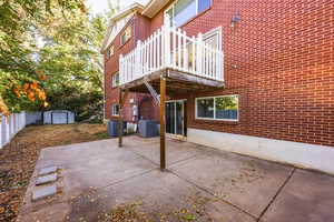 View of patio featuring a deck, a storage shed, and central air condition unit