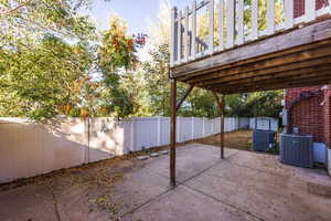 View of patio with central AC unit, a storage shed, and a wooden deck