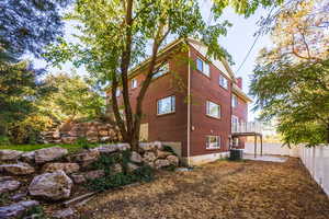 View of side of property with cooling unit