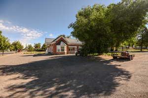 View of front of home with a metal roof and brick siding