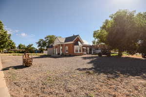 View of home's exterior with brick siding and a metal roof
