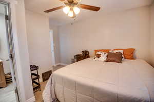 Carpeted bedroom with ceiling fan