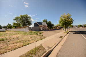 View of asphalt road with sidewalks and curbs