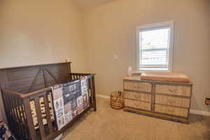 Bedroom featuring light colored carpet