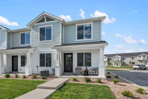 View of front of property featuring a front yard, a porch, and central AC unit