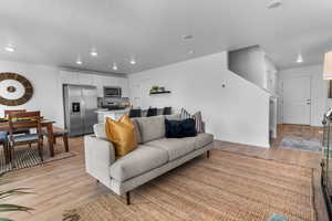 Living room featuring a textured ceiling, light hardwood / wood-style flooring, and sink