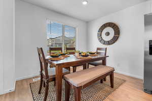 Dining area with light wood-type flooring