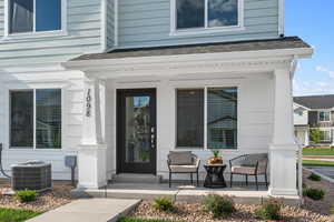 Doorway to property featuring central AC unit