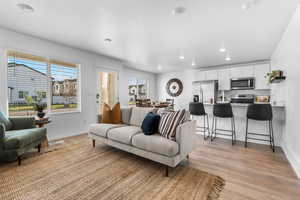 Living room with plenty of natural light and light wood-type flooring