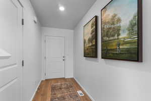 Doorway with hardwood / wood-style floors