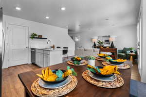 Dining space featuring sink, light hardwood / wood-style floors, and a textured ceiling