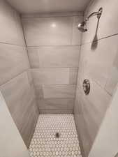 Bathroom featuring a tile shower and tile patterned floors