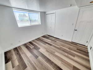 Unfurnished bedroom with a closet, light hardwood / wood-style floors