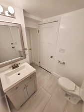 Bathroom featuring tile patterned flooring, vanity, and toilet