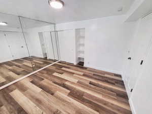 Unfurnished bedroom with hardwood / wood-style flooring