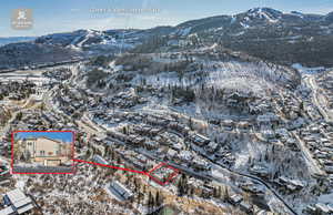 Snowy aerial view featuring a mountain view