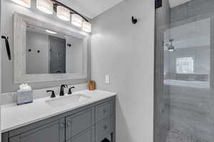 Bathroom featuring vanity and an enclosed shower