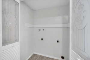 Laundry area featuring electric dryer hookup, hookup for a washing machine, and light wood-type flooring