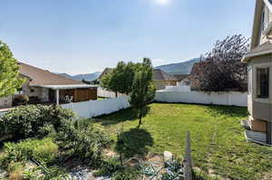 View of yard featuring a mountain view and a fenced backyard