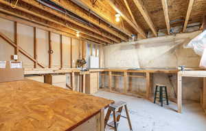 Unfinished basement with a workshop area