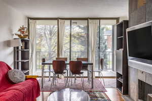 Interior space with a fireplace, plenty of natural light, floor to ceiling windows, and light hardwood / wood-style flooring