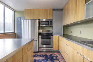 Kitchen featuring light brown cabinets and stainless steel appliances