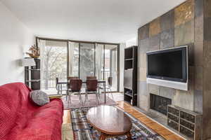 Living room featuring hardwood / wood-style flooring and a tile fireplace