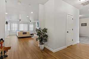 Hallway with light hardwood / wood-style floors