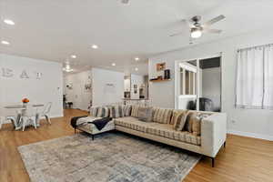 Living room featuring ceiling fan and light hardwood / wood-style floors