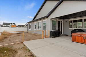 View of patio / terrace featuring area for grilling and a hot tub