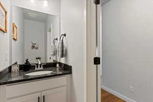 Bathroom with vanity and hardwood / wood-style flooring