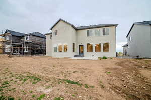Back of property featuring a patio area and stucco siding