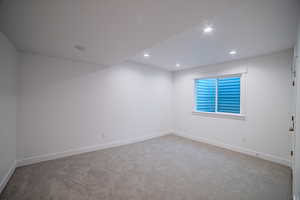 Empty room featuring recessed lighting, baseboards, and carpet floors