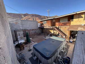 View of patio / terrace with a jacuzzi and a mountain view