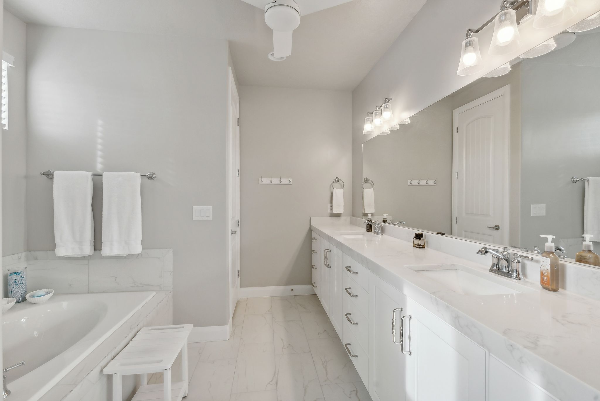 Primary Bathroom suite with vanity and a tub to relax in