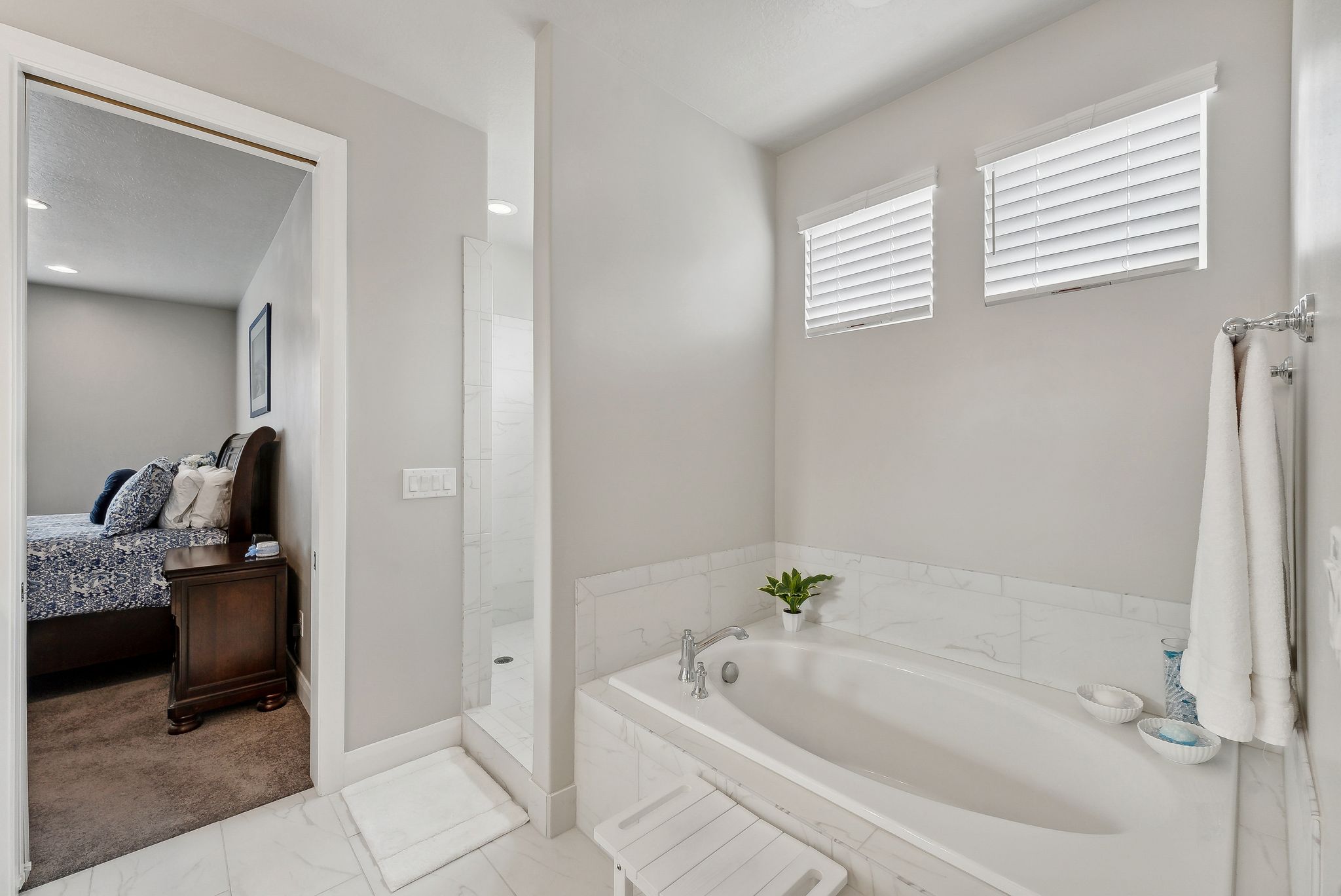 Primary Bathroom featuring shower with separate bathtub