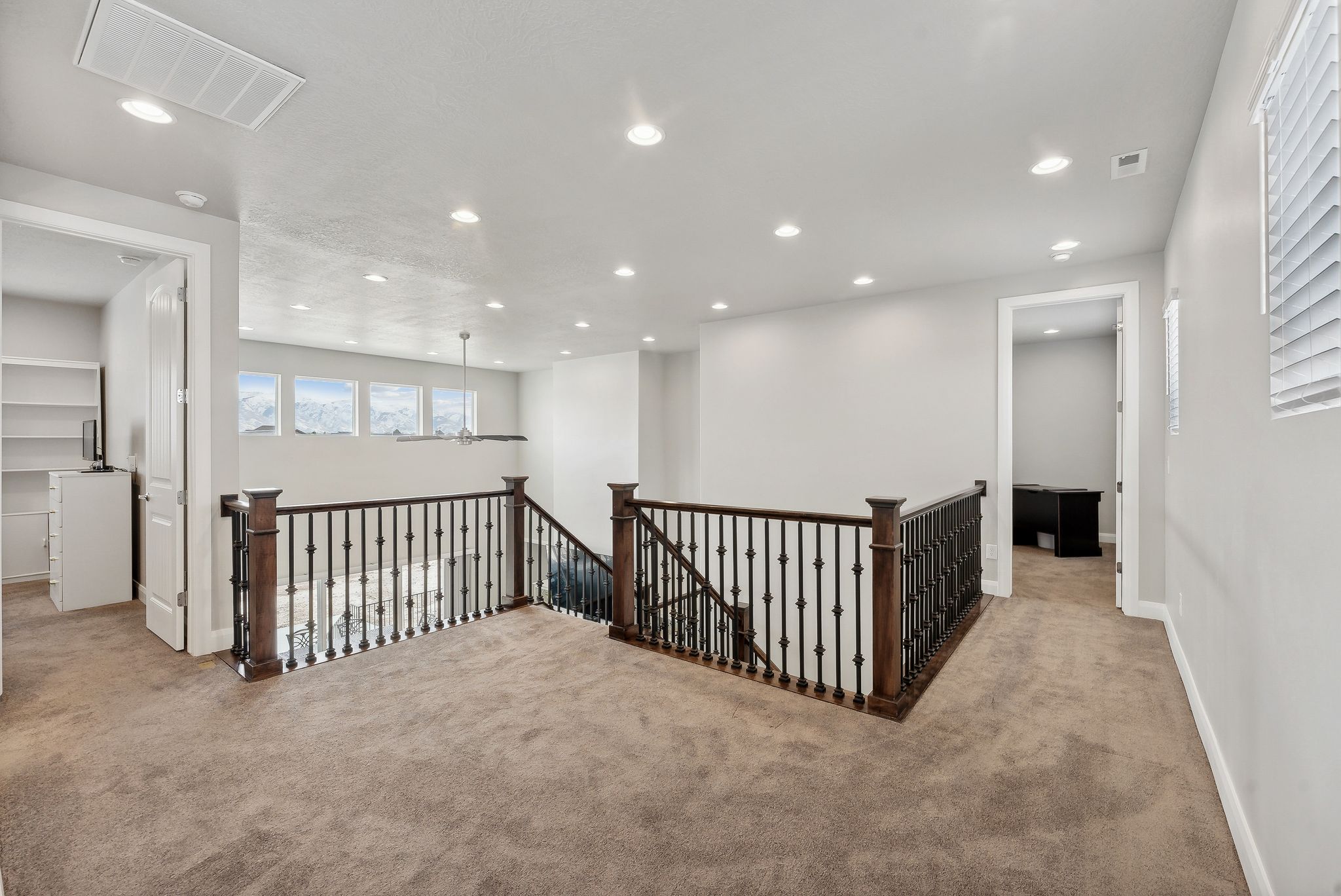 Hallway featuring light carpet