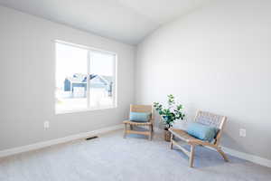 Sitting room featuring lofted ceiling and carpet floors