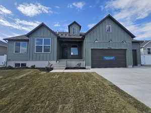 View of front of home featuring a garage and a front yard