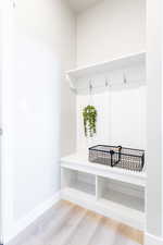 Mudroom with wood-type flooring