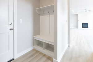 Mudroom with ceiling fan and light hardwood / wood-style flooring