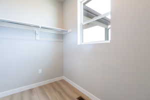 Spacious closet featuring hardwood / wood-style floors