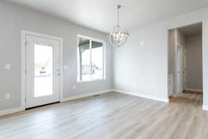 Interior space featuring a chandelier and light wood-type flooring