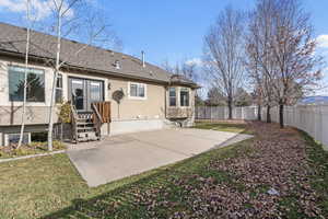 Rear view of house featuring a patio area and a lawn